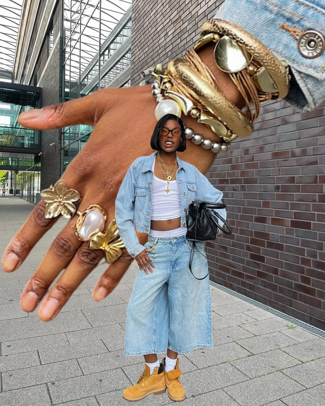 Woman layering white tank with denim on denim and boots