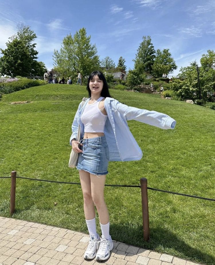 Model layering white tank under white shirt