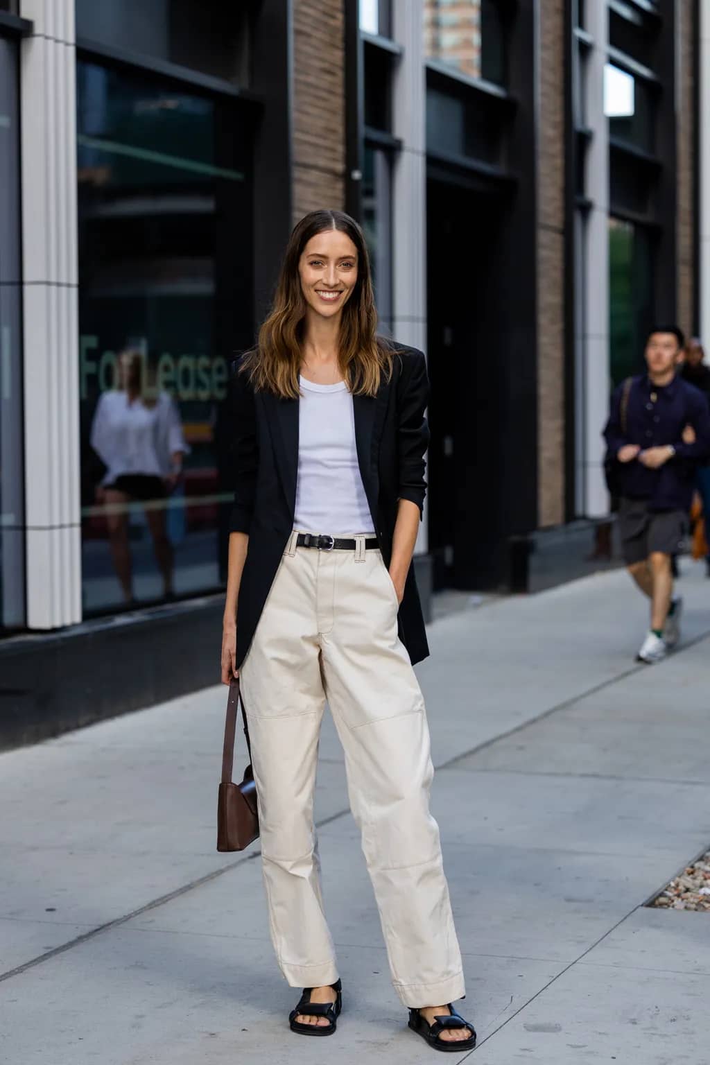 Model in tailored blazer over white tank