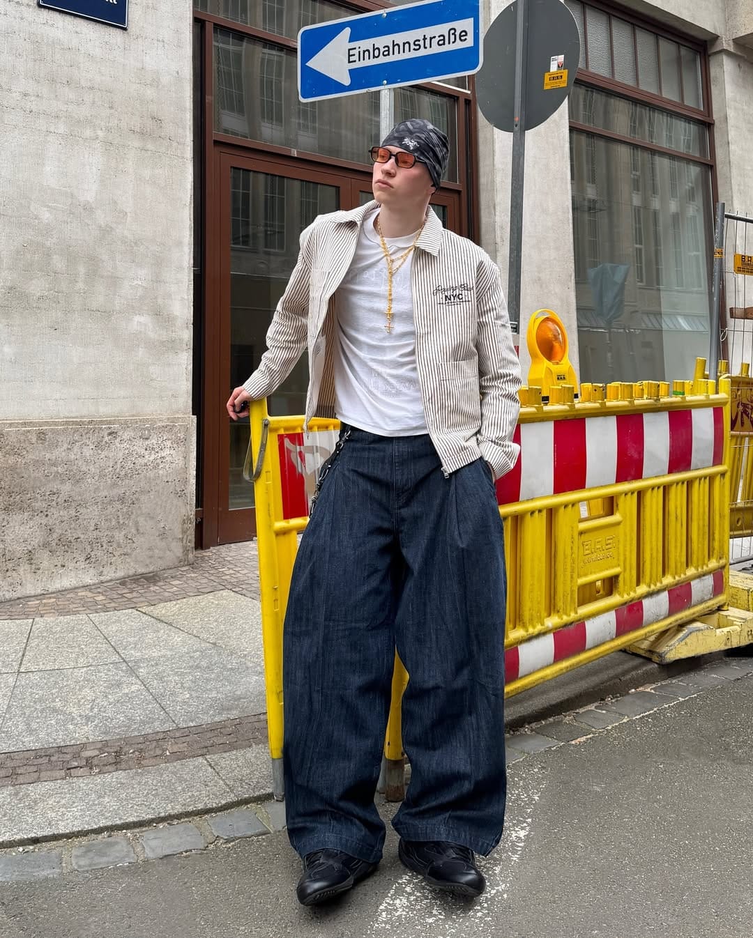 Man wearing baggy jeans with striped shirt